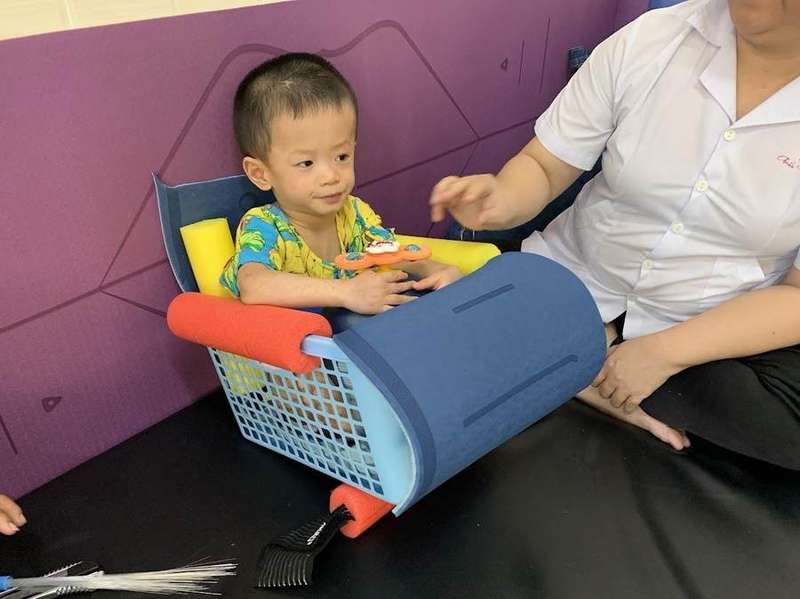 Child supported in an adapted seating device